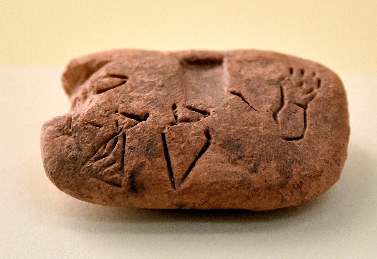 A small clay tablet with an early counting sign pressed into it