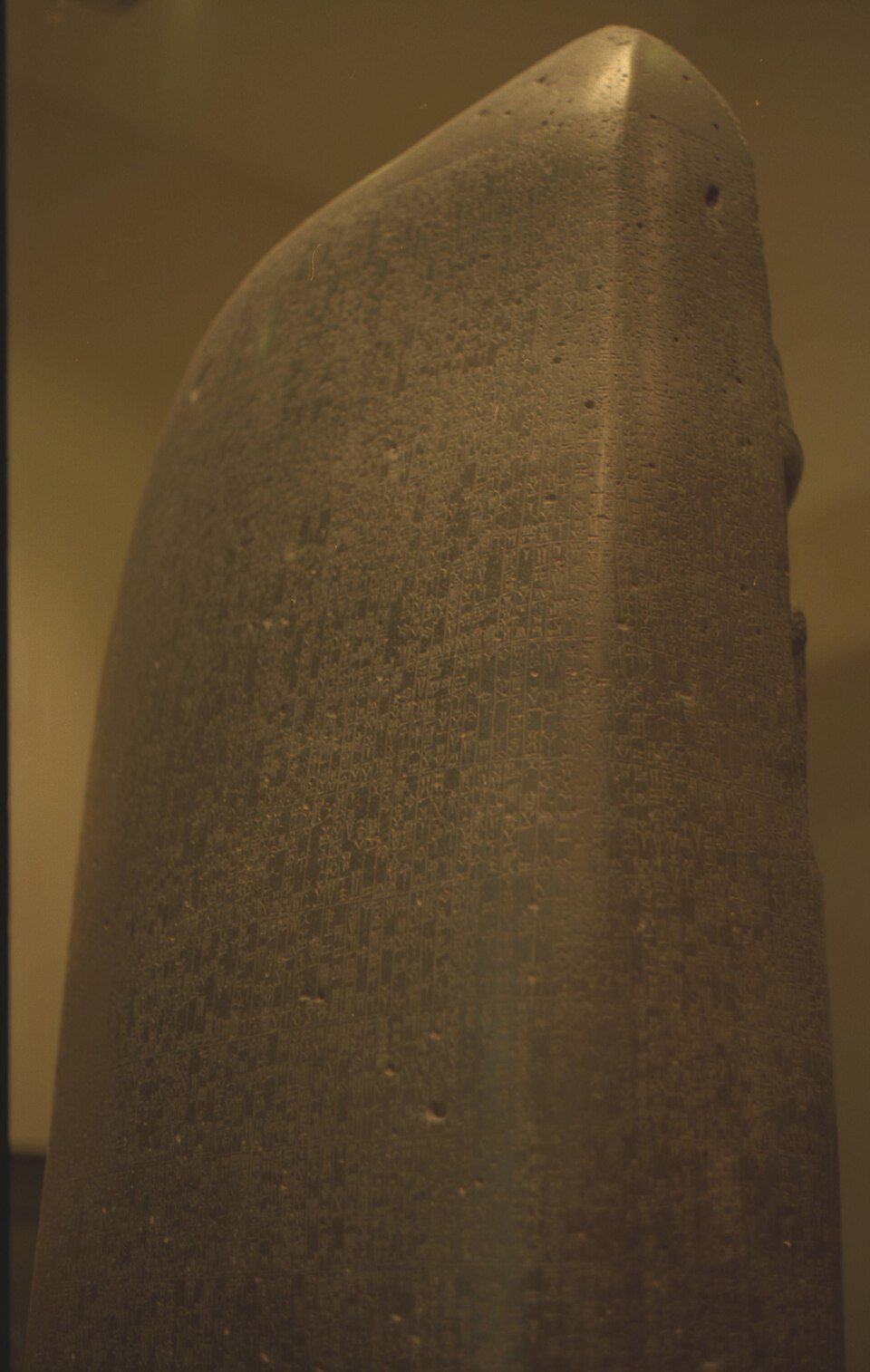 A tall basalt stele, law text below a carved king-and-god scene