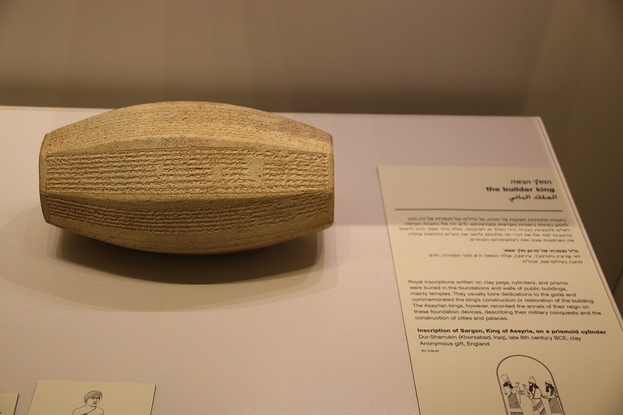 A clay cylinder covered in cuneiform, inscribed for King Sargon II of Assyria.