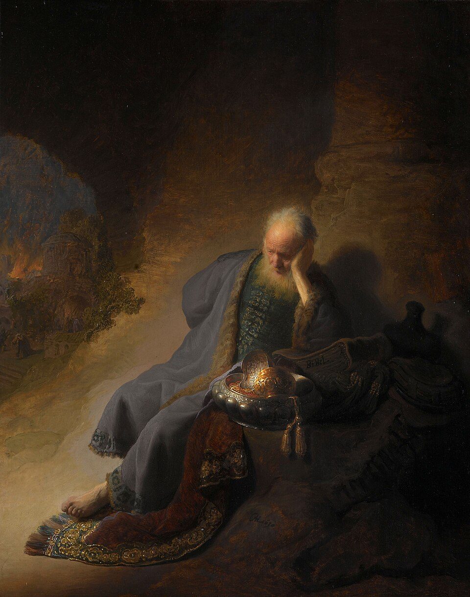 An old man sits grieving beside gold temple vessels, a burning city behind him.