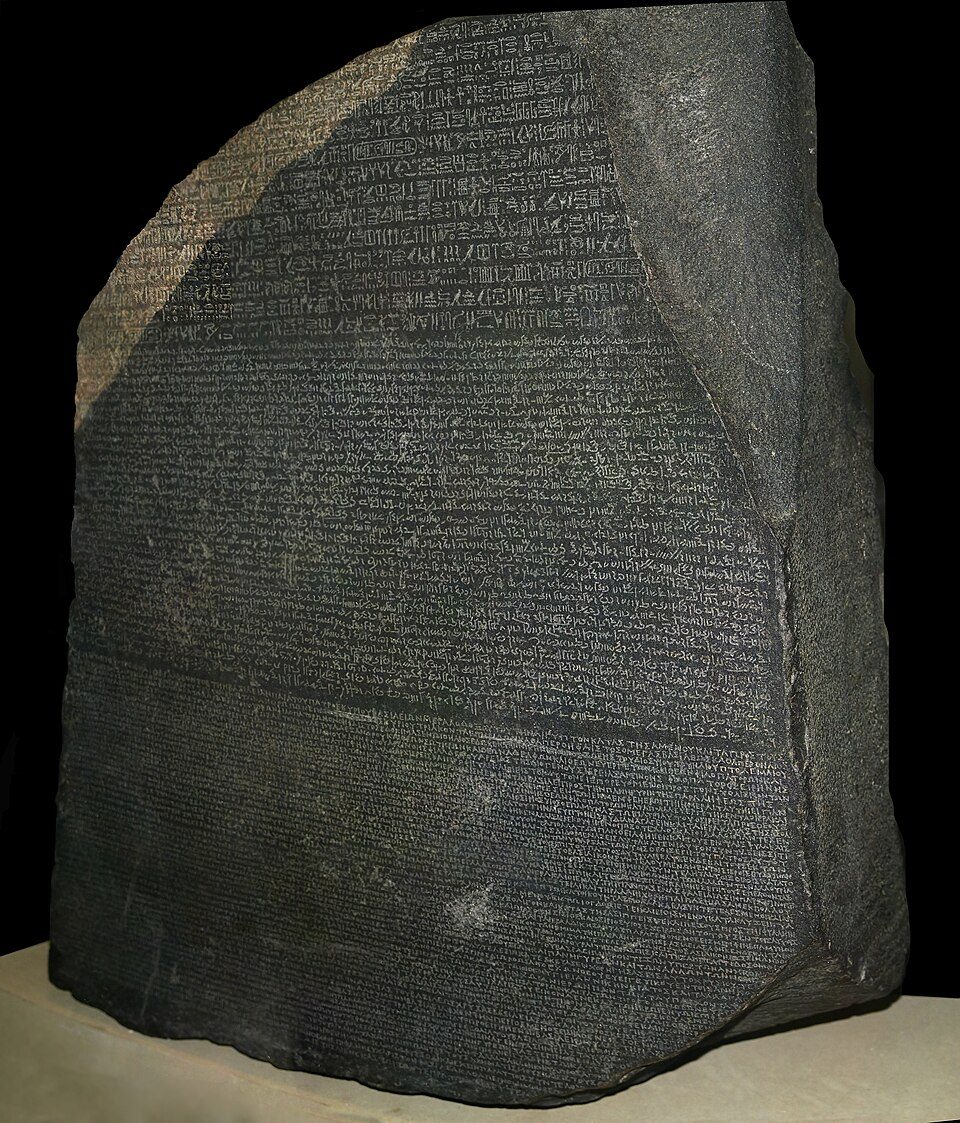 A carved stone with the same decree written in three scripts, one Greek.