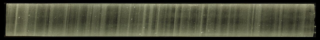A long scanned strip of a Greenland ice core showing its layered structure