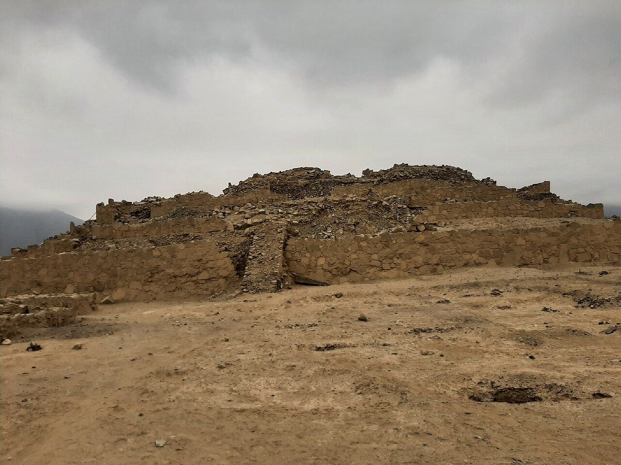 A large stepped earthen pyramid mound at the ancient city of Caral